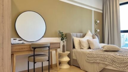 Elegant bedroom with modern interior design featuring a cozy bed and stylish desk.